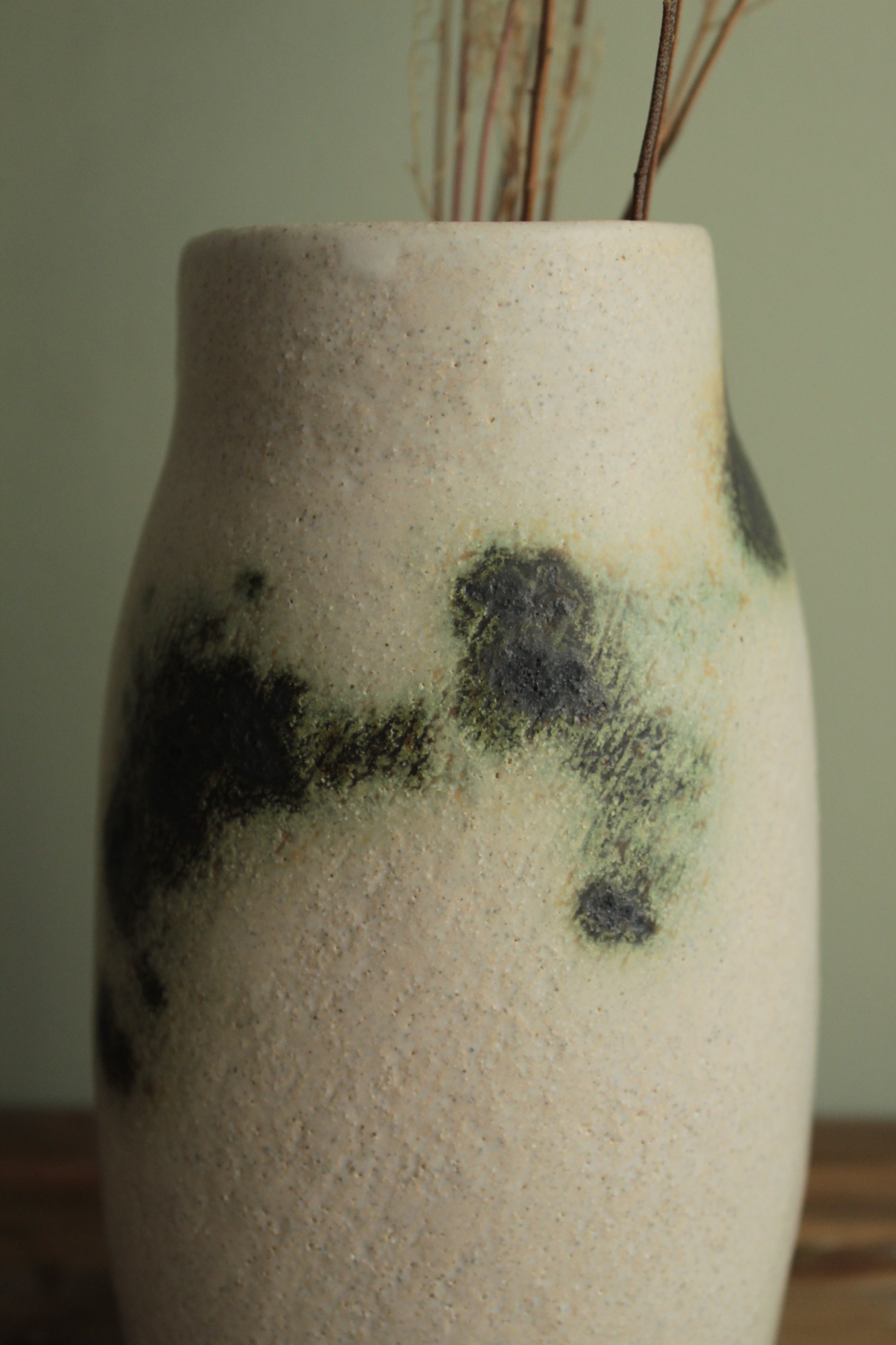 White vase with green design