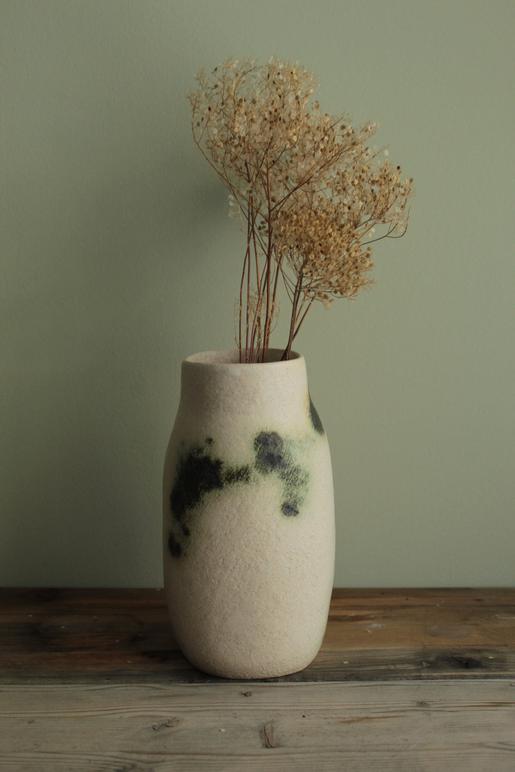White vase with green design