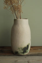 White vase with green design