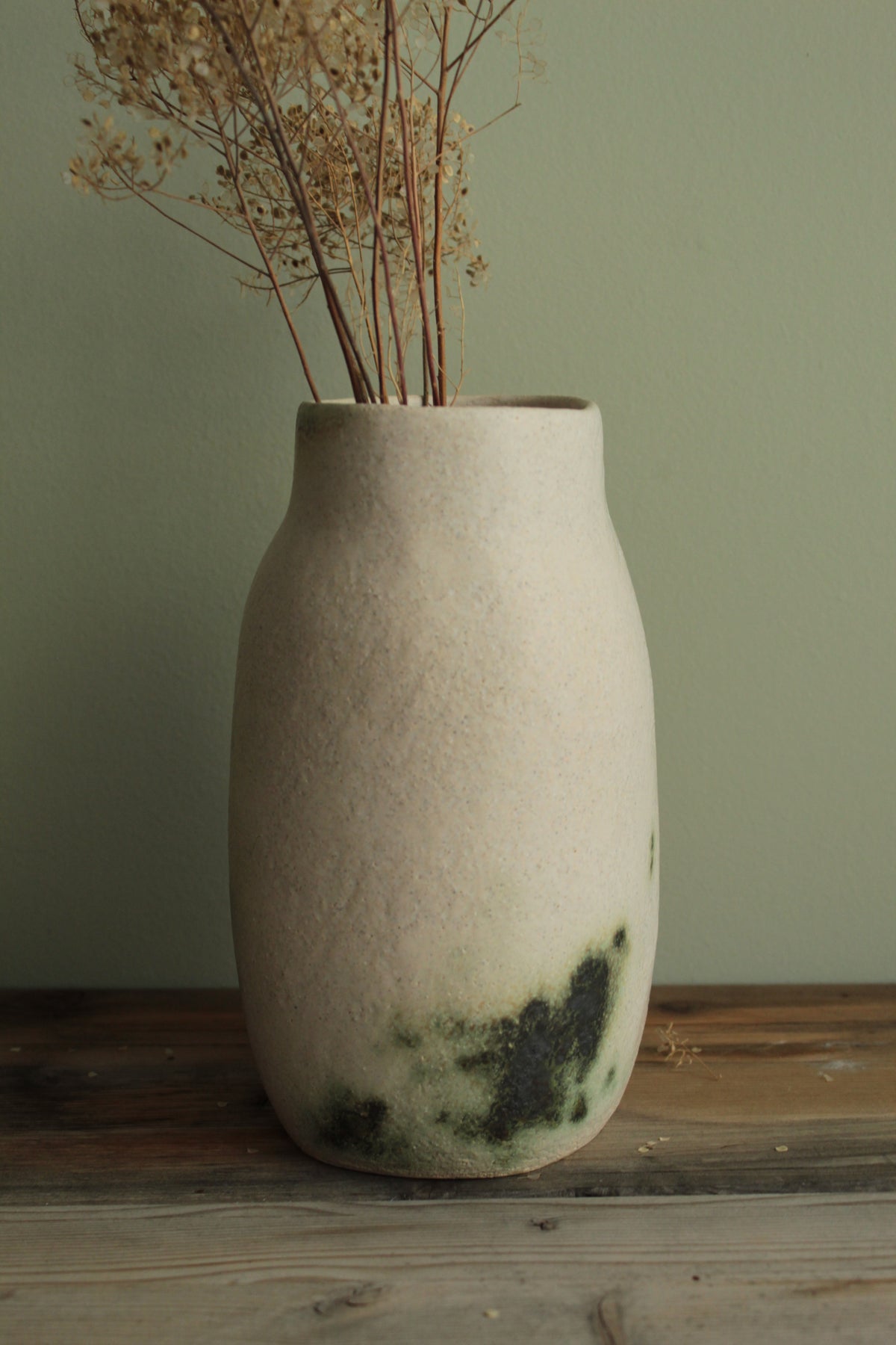 White vase with green design
