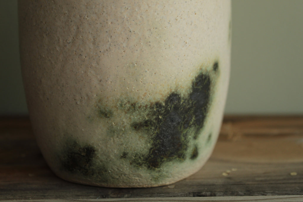 White vase with green design