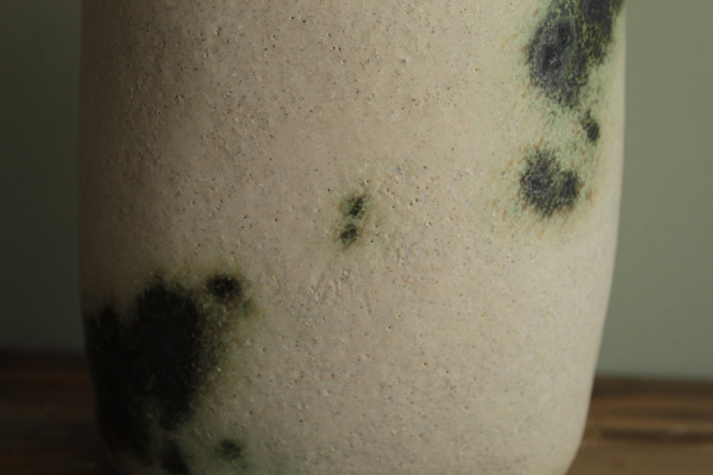 White vase with green design