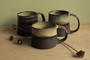 Light beige and black mug