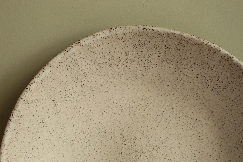 White platter/ bowl with black stones