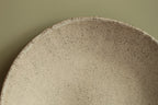 White platter/ bowl with black stones