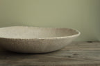 White platter/ bowl with black stones