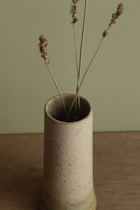 Narrow white speckled vase