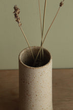 Narrow white speckled vase