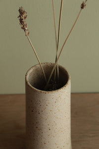 Narrow white speckled vase