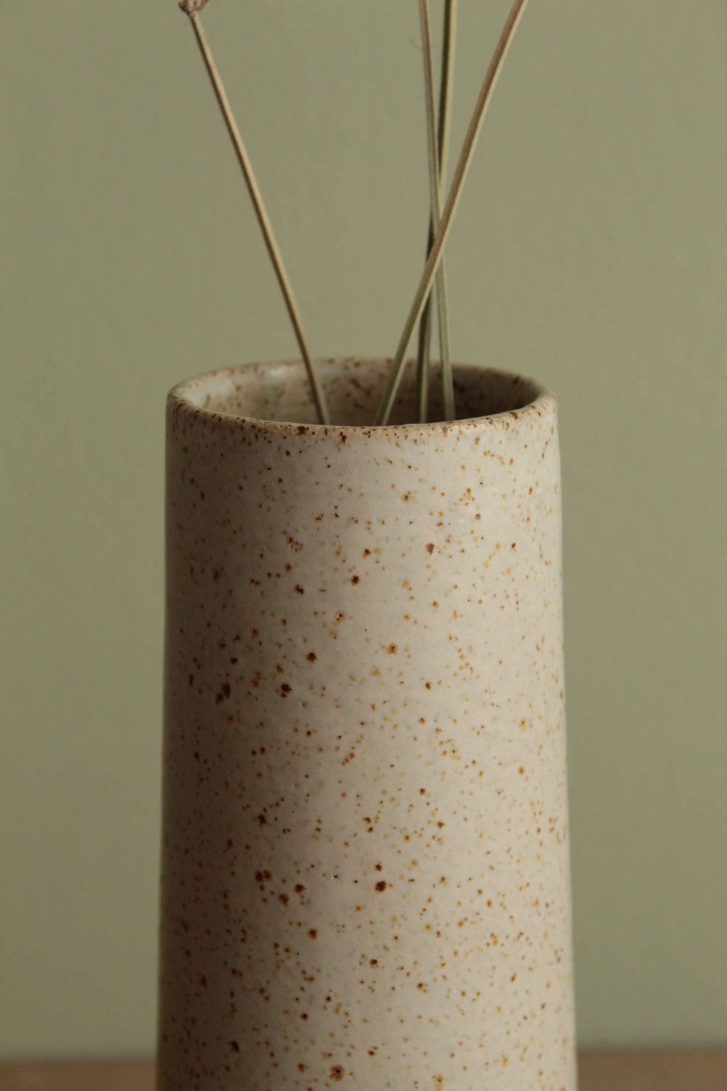 Narrow white speckled vase
