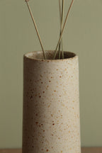 Narrow white speckled vase