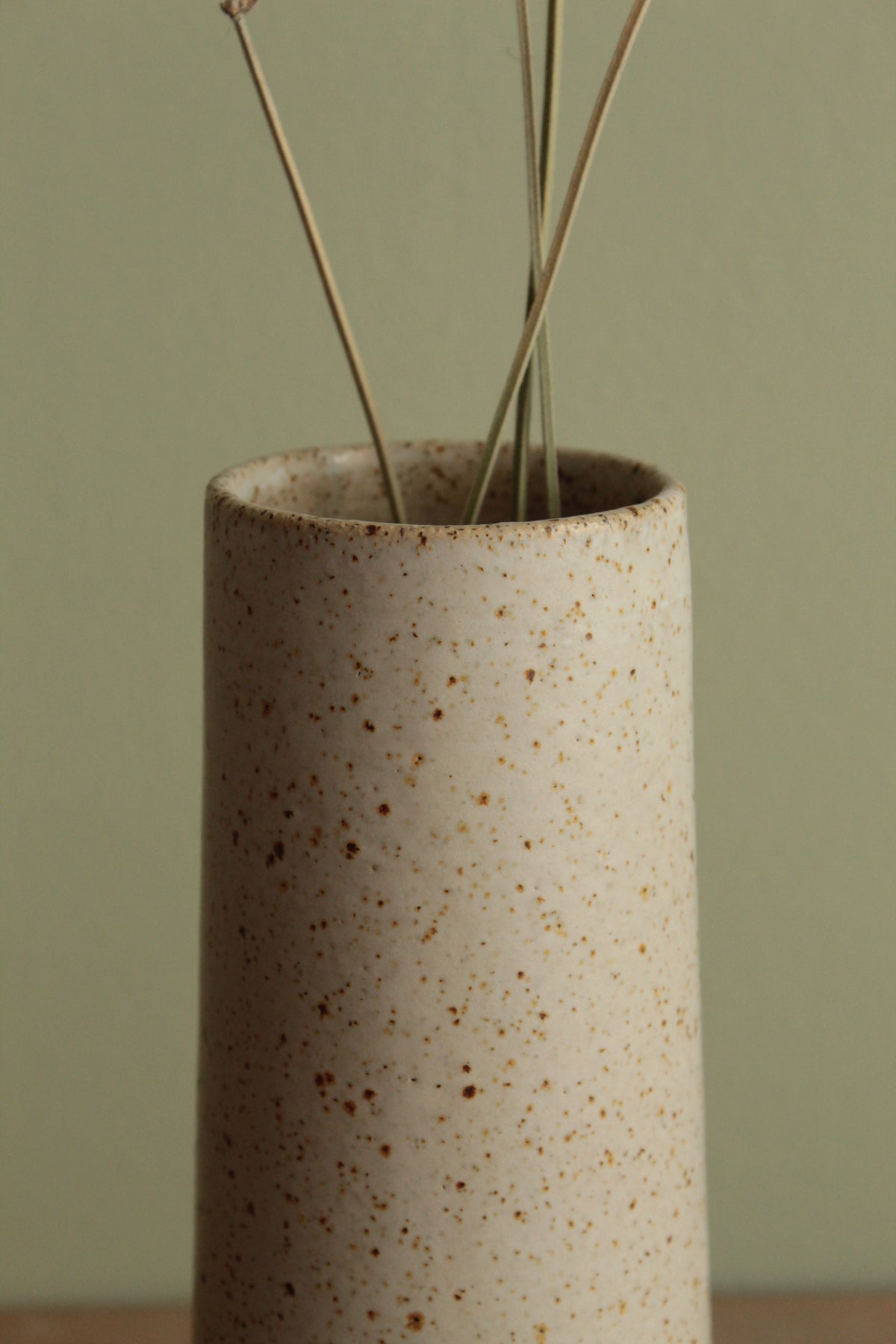 Narrow white speckled vase