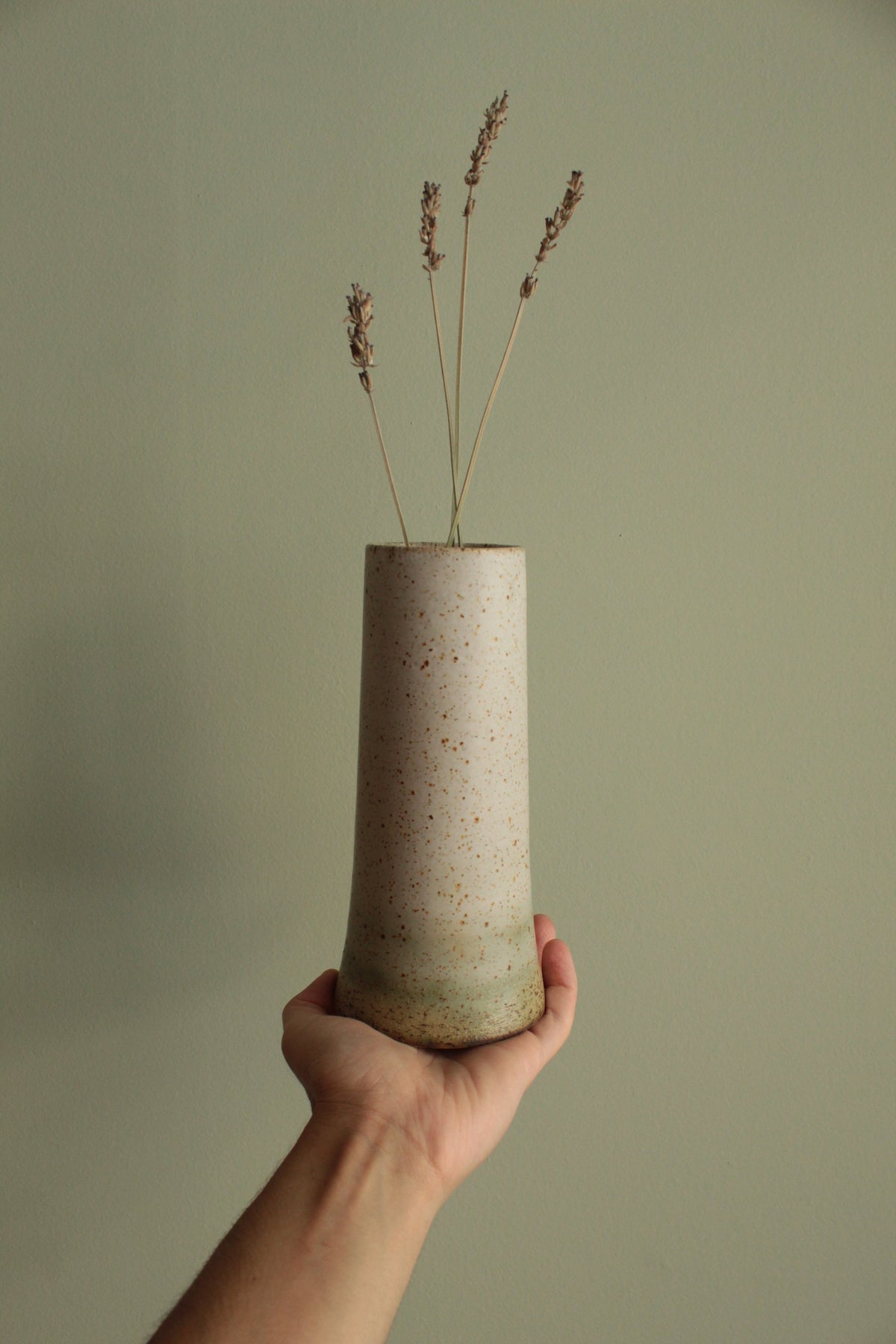 Narrow white speckled vase