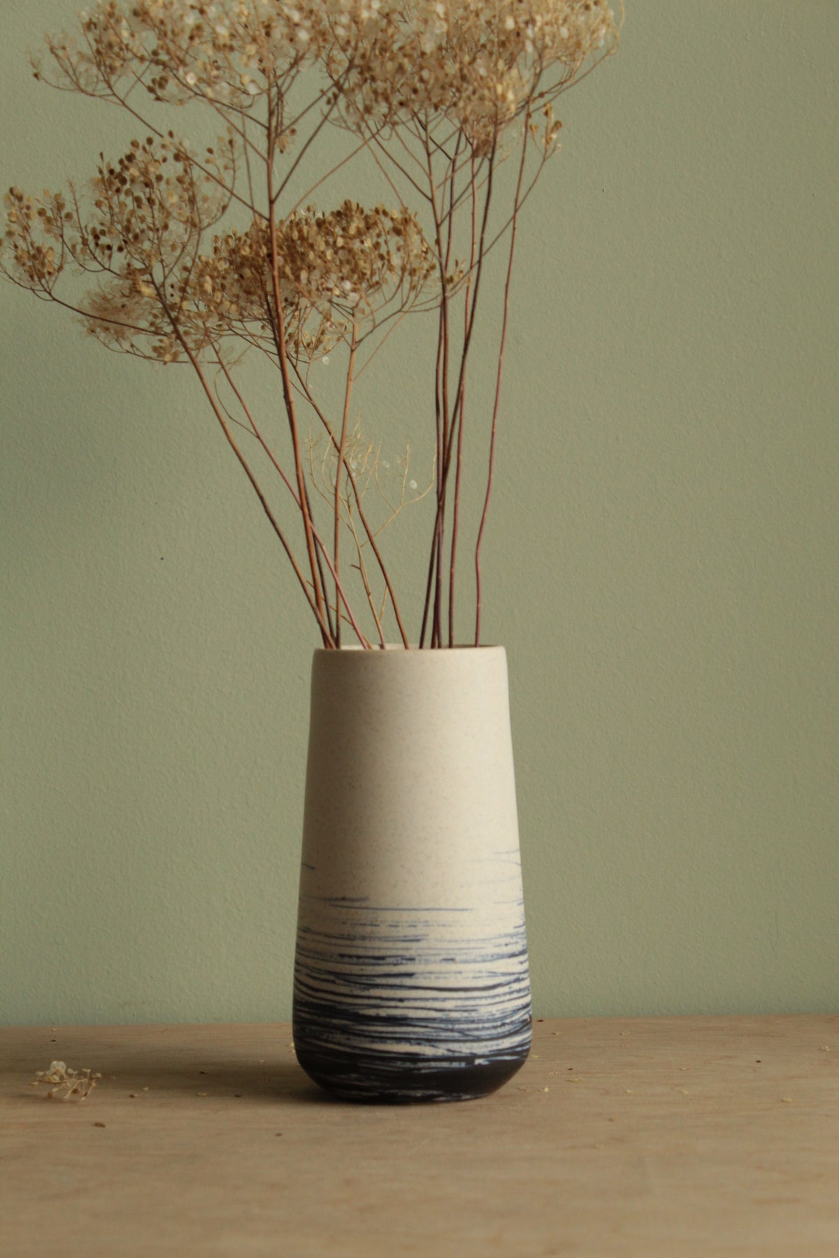 White vase with blue lines