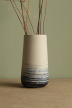 White vase with blue lines