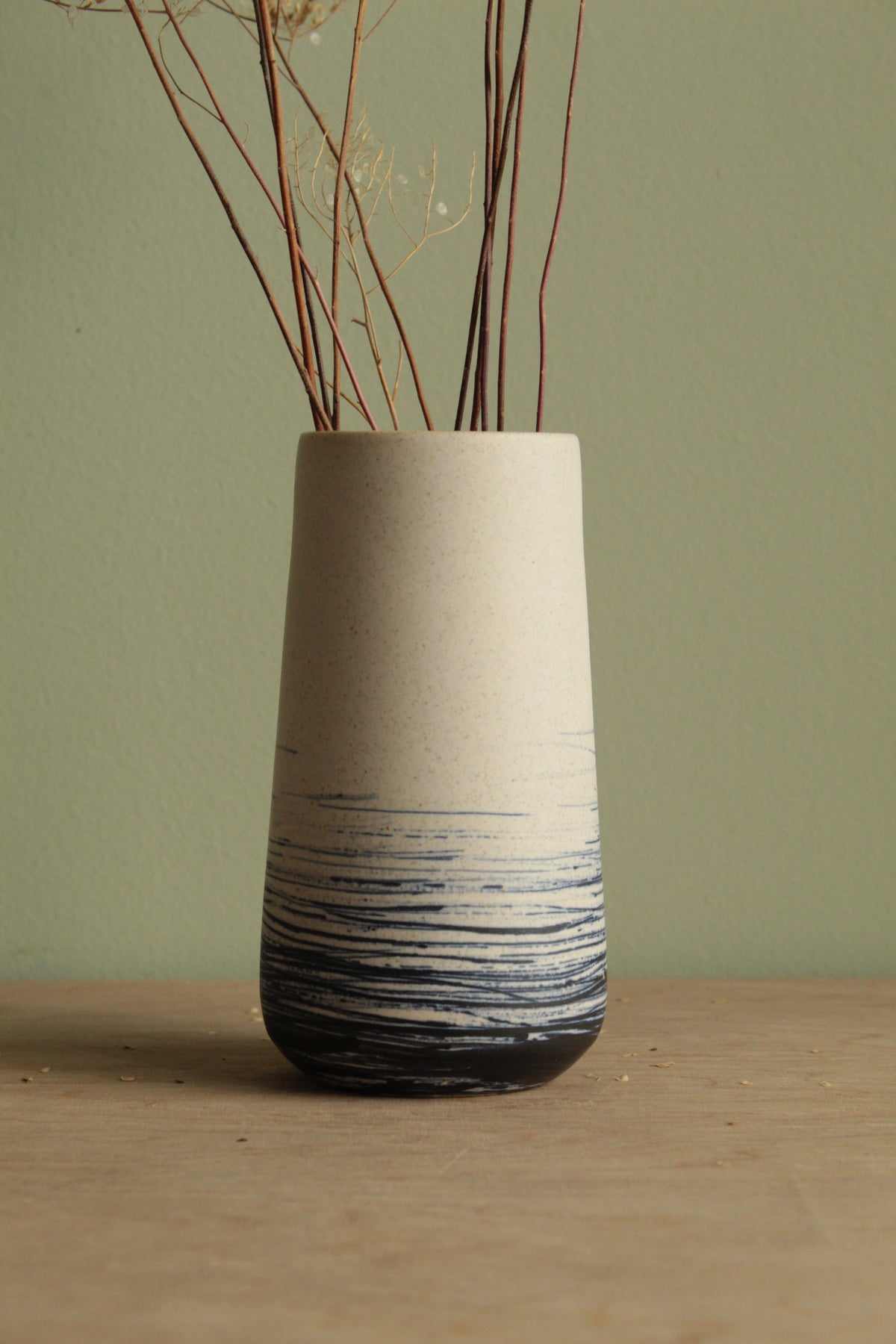 White vase with blue lines