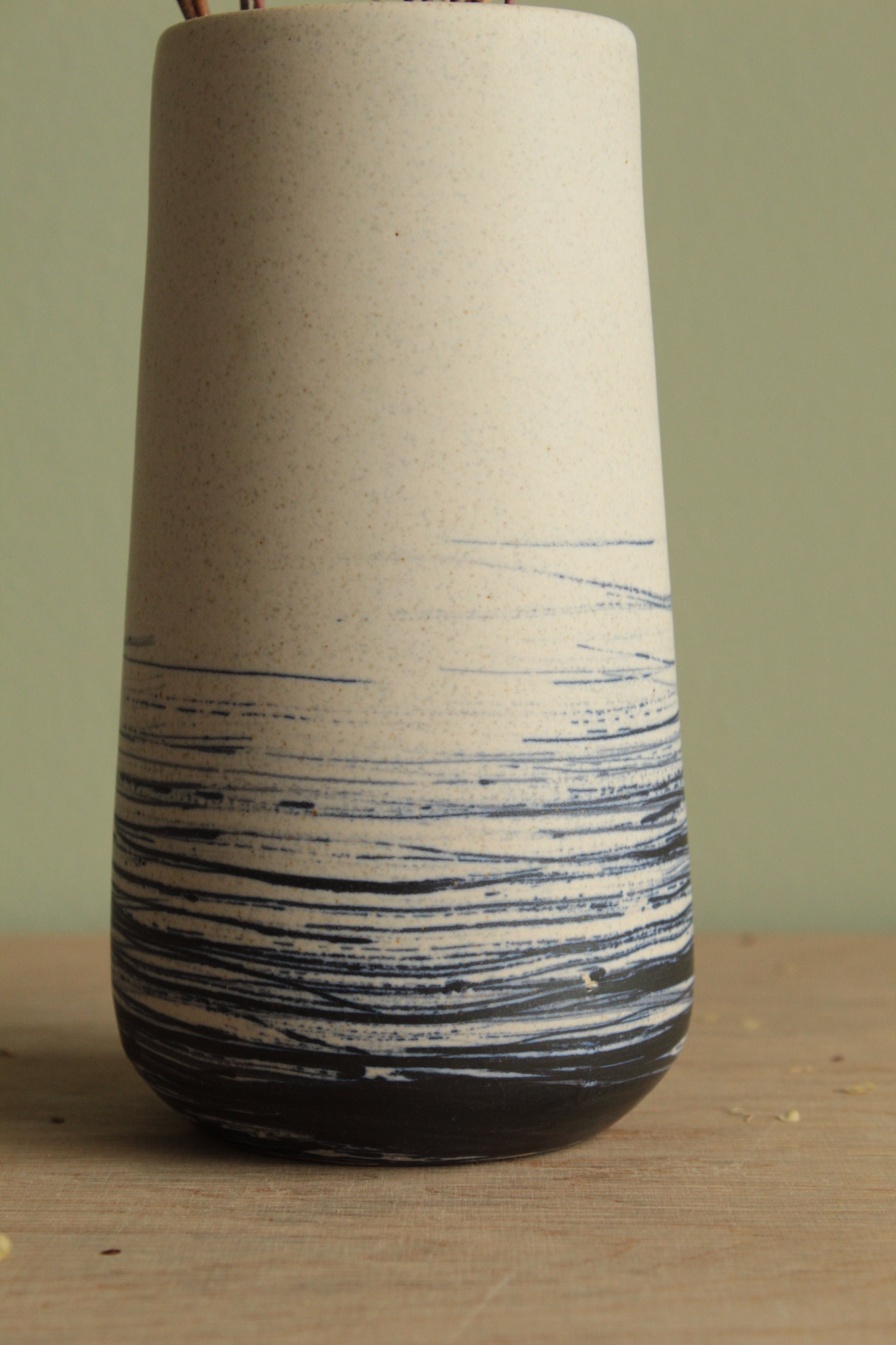 White vase with blue lines