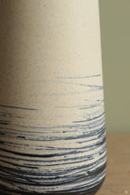 White vase with blue lines