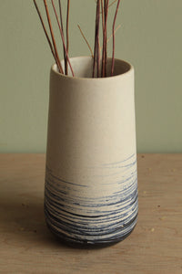 White vase with blue lines