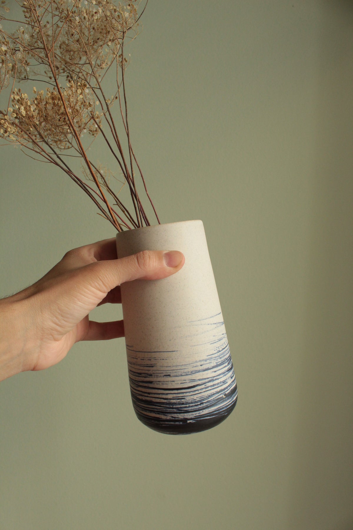 White vase with blue lines