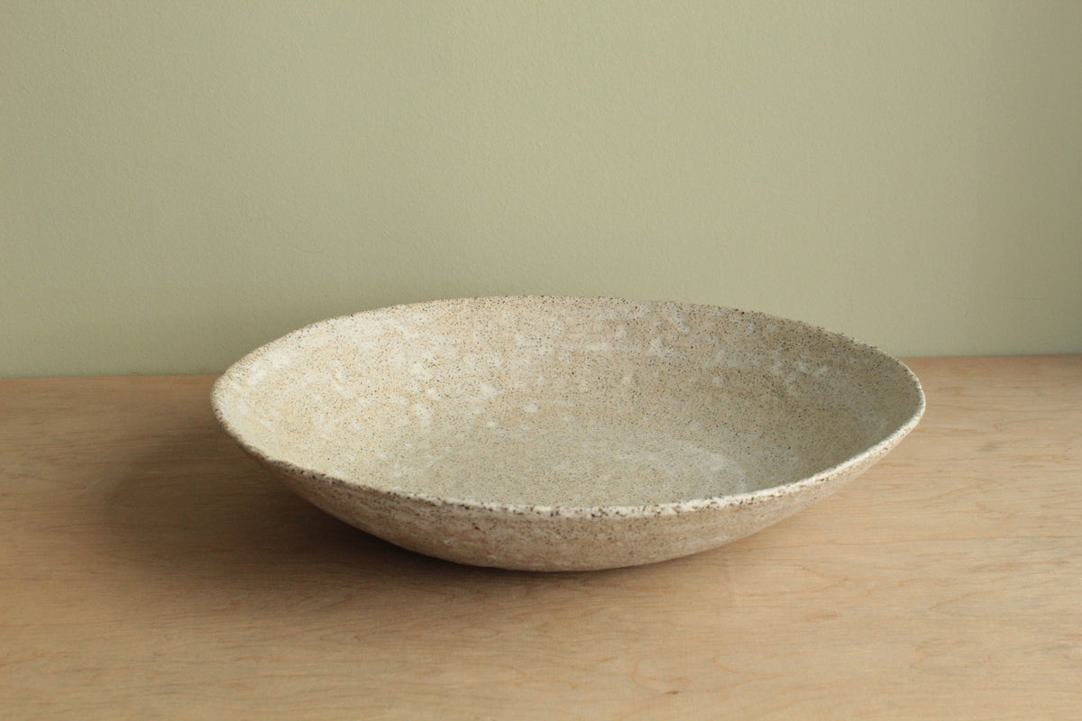 White platter/ bowl with black stones