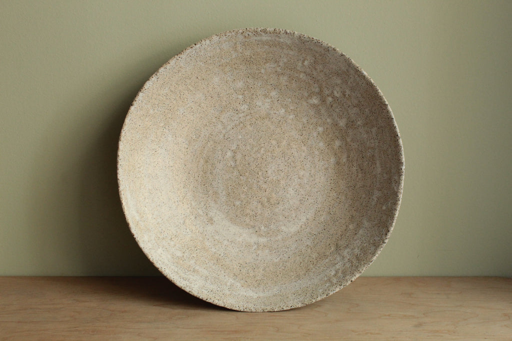 White platter/ bowl with black stones