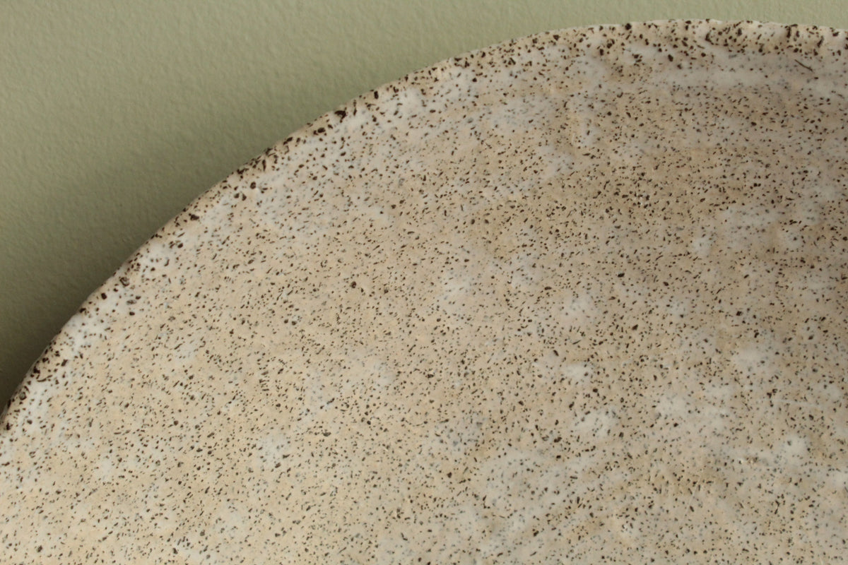 White platter/ bowl with black stones