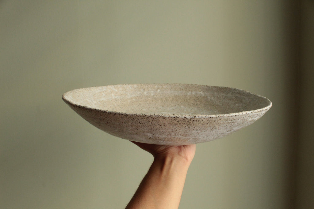 White platter/ bowl with black stones
