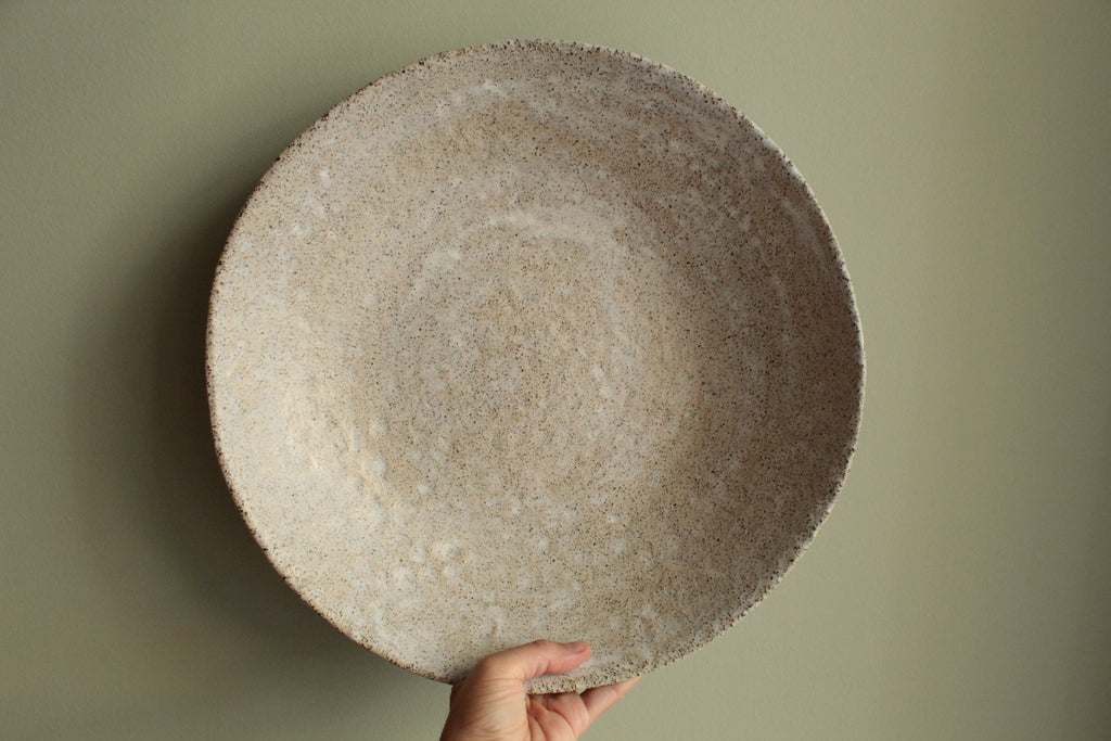 White platter/ bowl with black stones