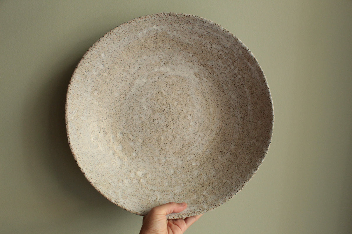 White platter/ bowl with black stones