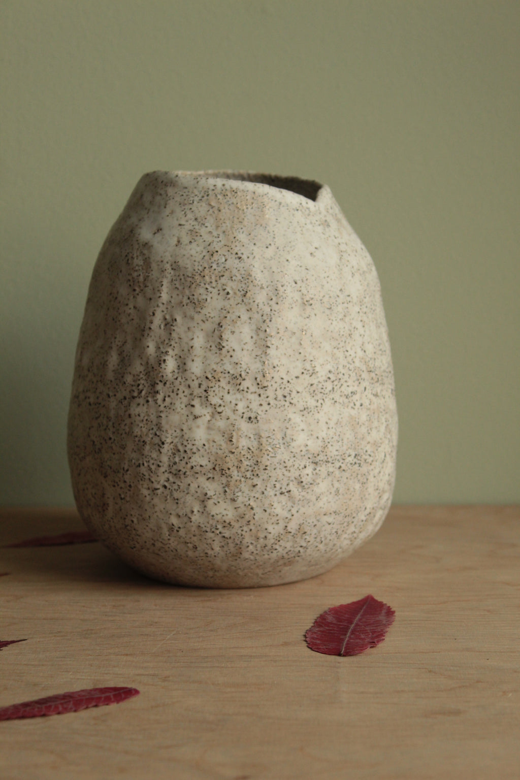 White vase with black rocks
