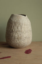 White vase with black rocks