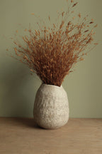 White vase with black rocks