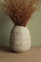 White vase with black rocks