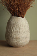 White vase with black rocks