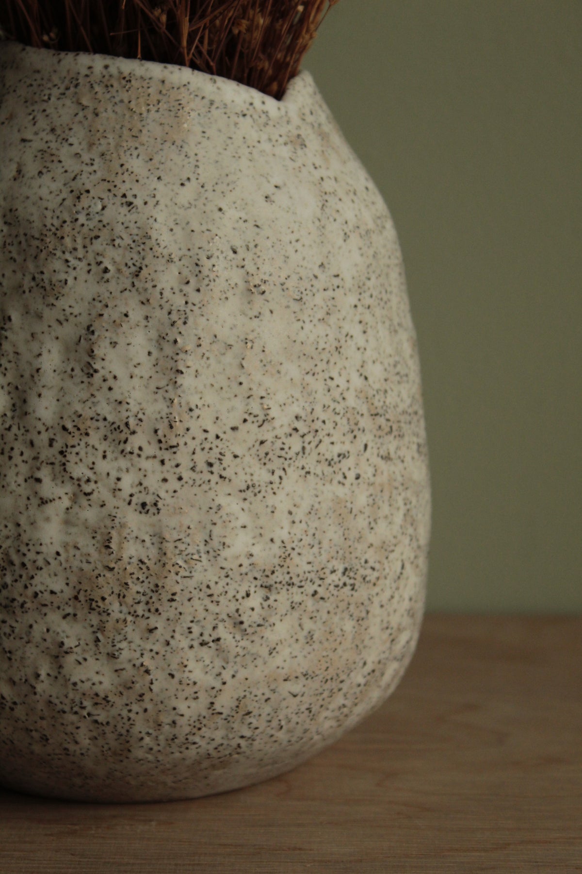 White vase with black rocks