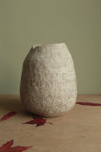 White vase with black rocks