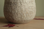 White vase with black rocks