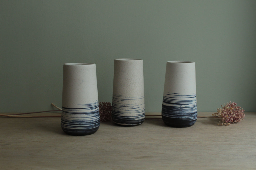 White vase with blue lines