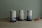White vase with blue lines