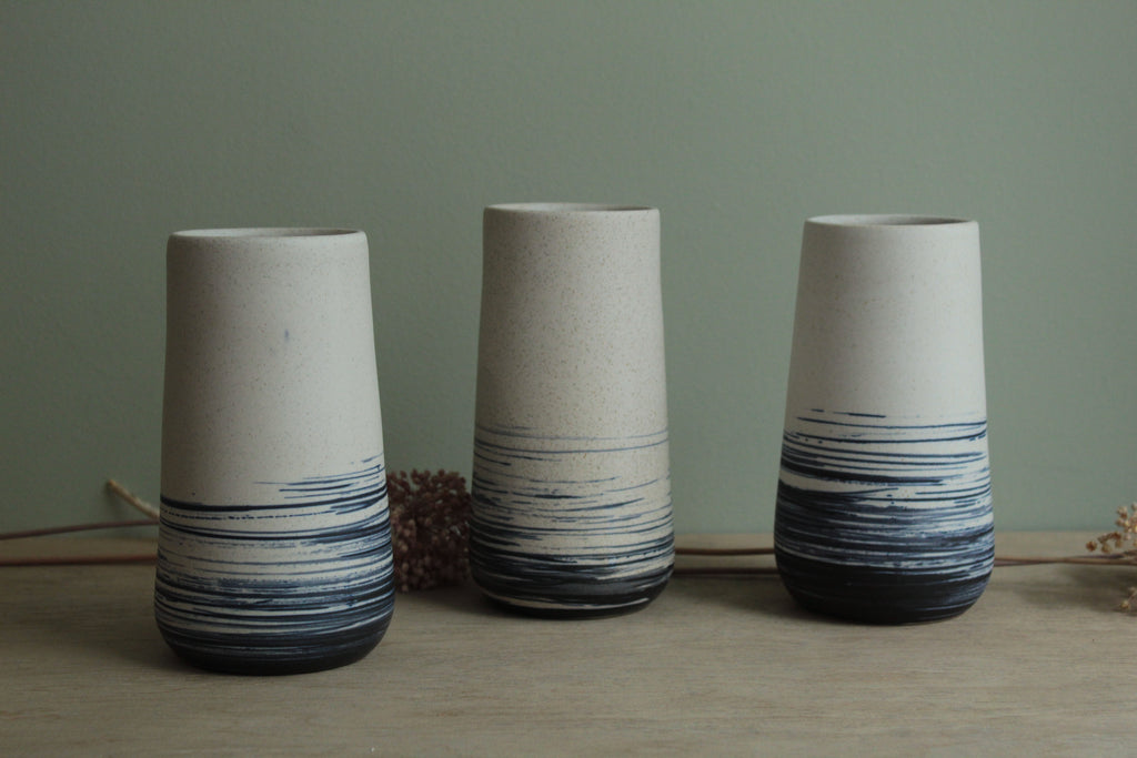 White vase with blue lines