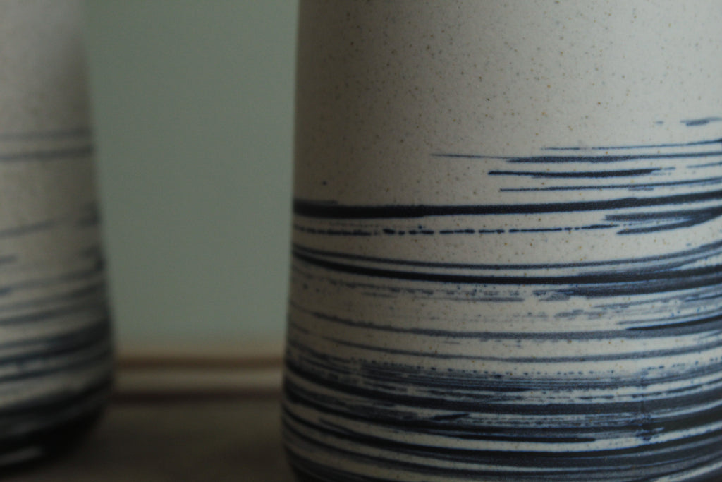 White vase with blue lines