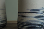 White vase with blue lines
