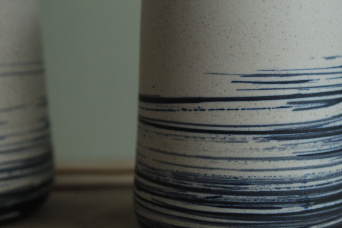 White vase with blue lines