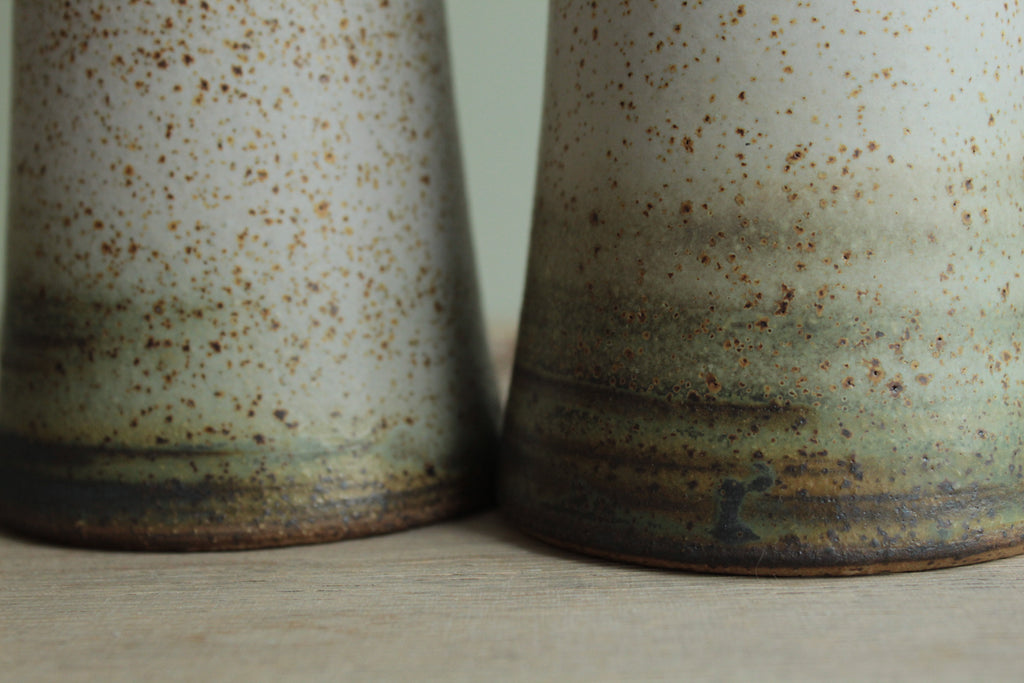 Narrow white speckled vase
